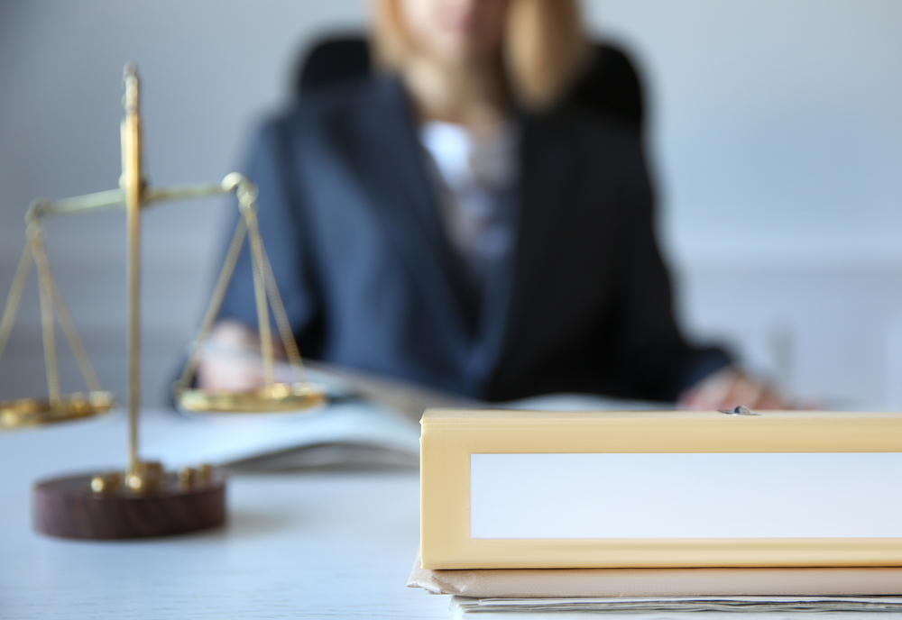 lawyer sitting behind the scales of justice