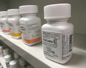 oxycontin sitting on the shelf in a pharmacy.