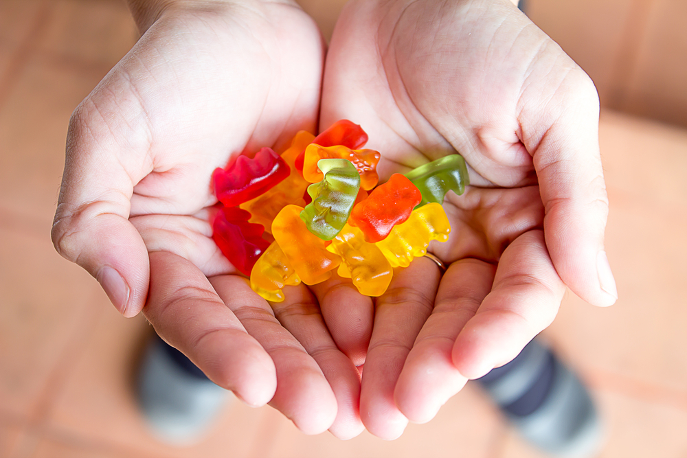 woman holding a handful of gummy bears