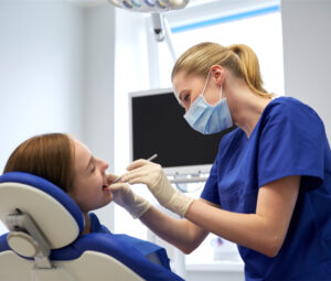 a dentist taking care of a young patient
