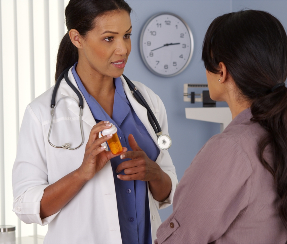 doctor talking to patient about prescription pills