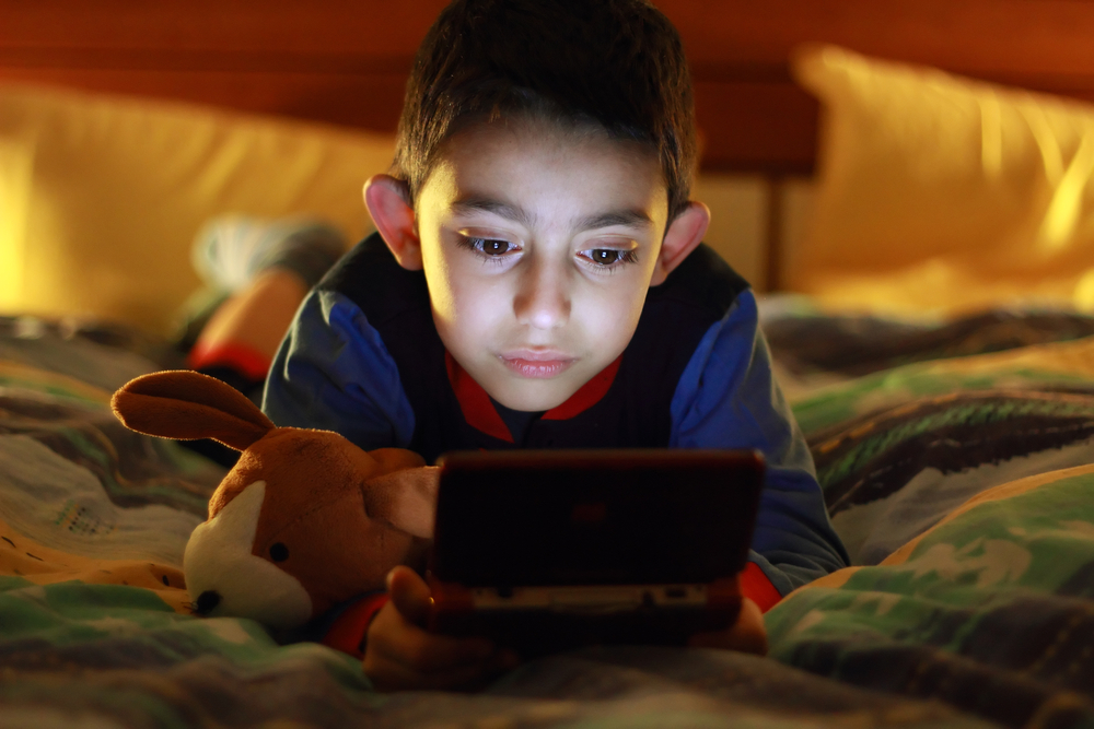 kid playing on tablet