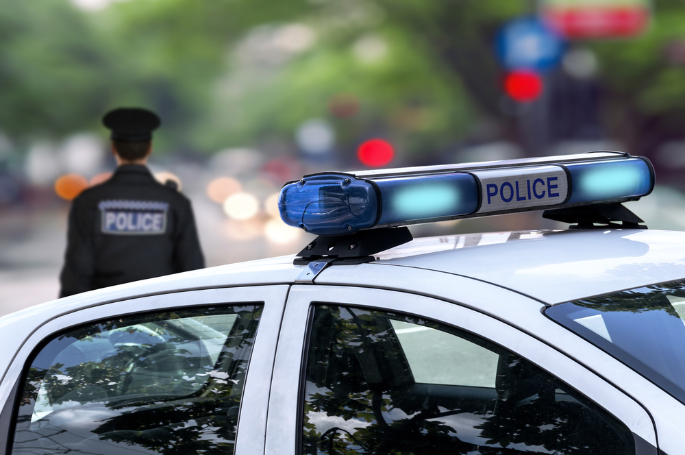 police officer standing near his service vehicle