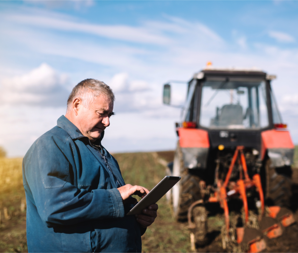 Farmer controls the work in the field over his electronic tablet