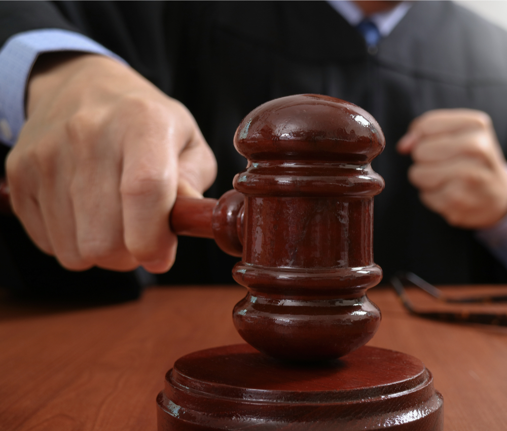 Judge in a courtroom striking the gavel,