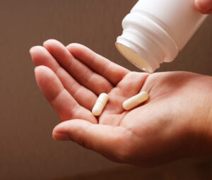 person pouring pills into hand