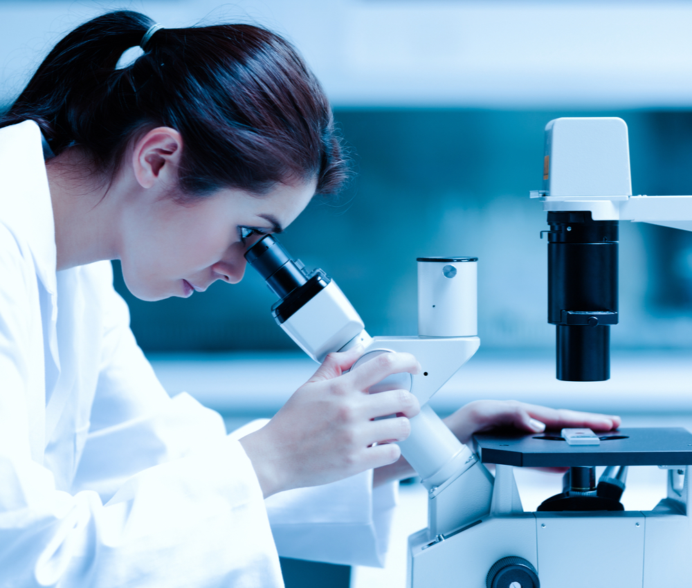 Scientist using a microscope in a laboratory