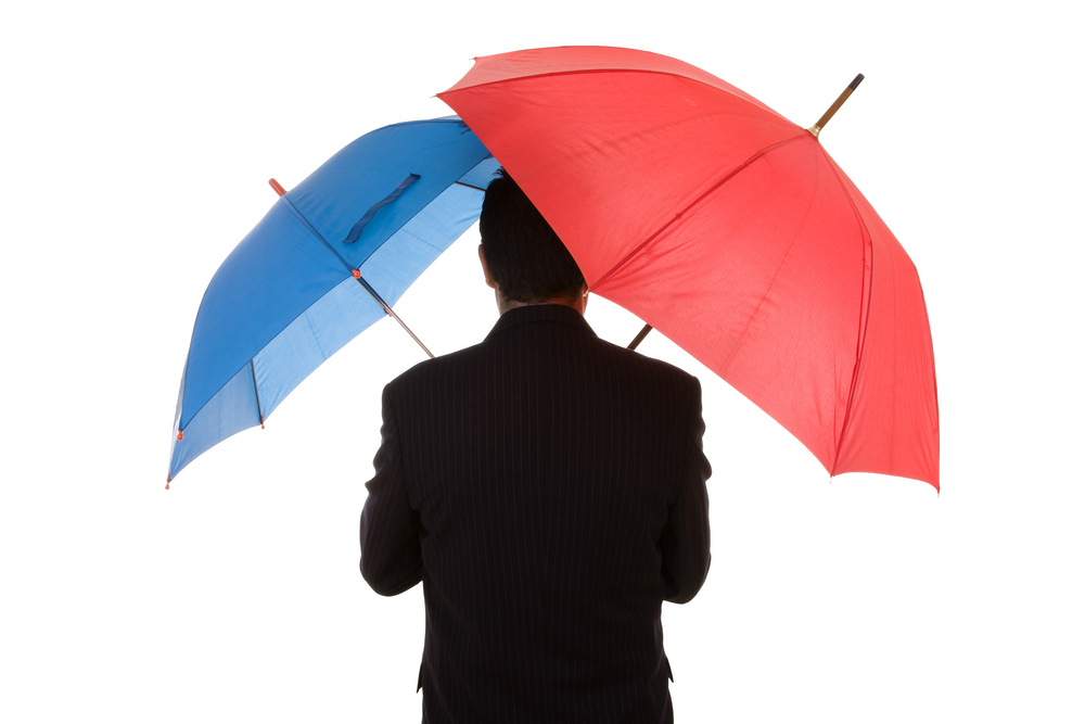 Double Agent holding a red umbrella and a blue umbrella