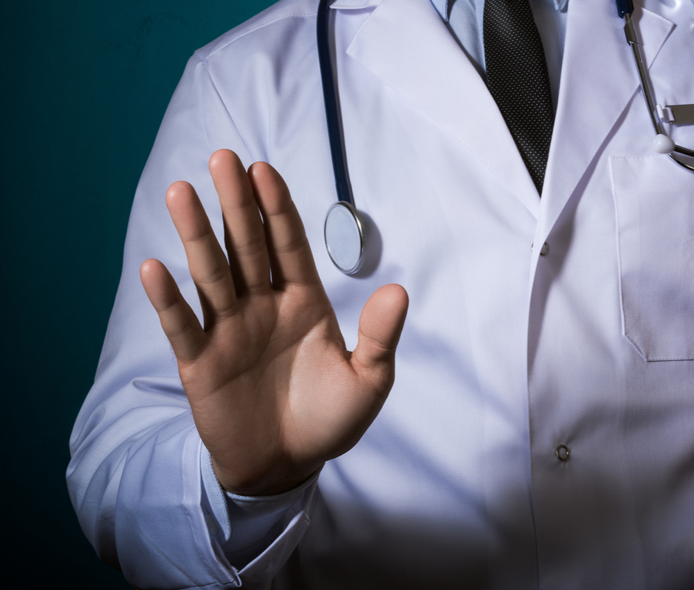 The doctor making a "stop" gesture with his hand