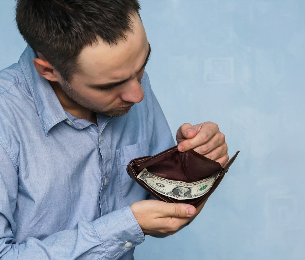 The guy counts the money in his wallet