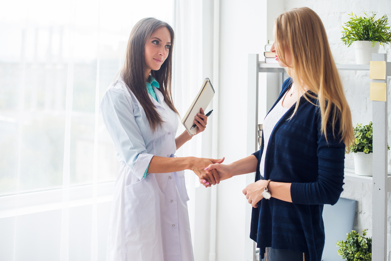 A doctor and patient shaking hands