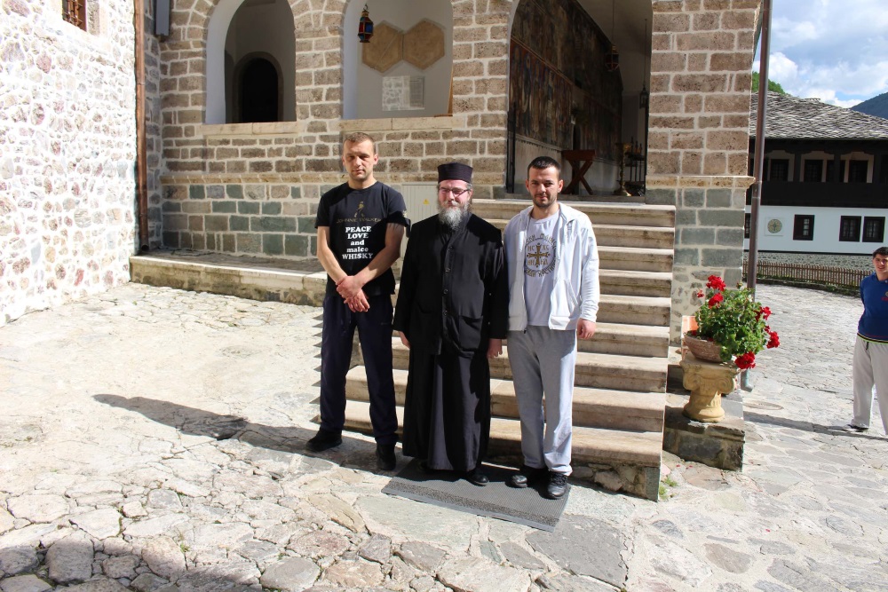 Three men in front of a Macedonian monastery