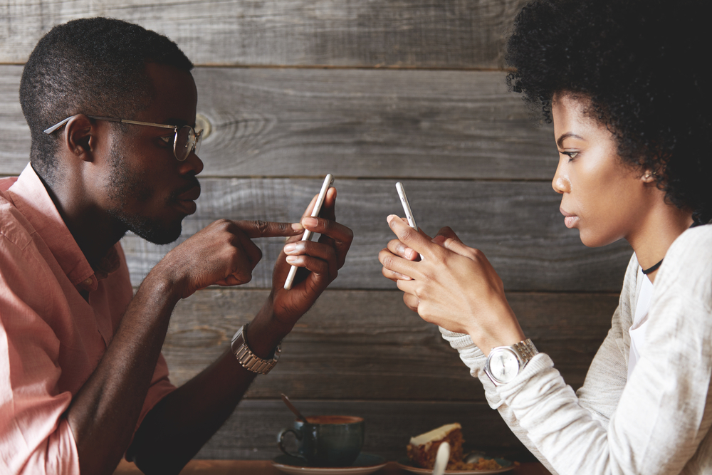 couple distracted by phones