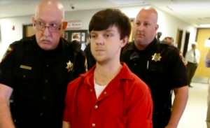 Ethan Couch being escorted by officers