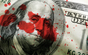 close-up of hundred dollar bill with blood spatter