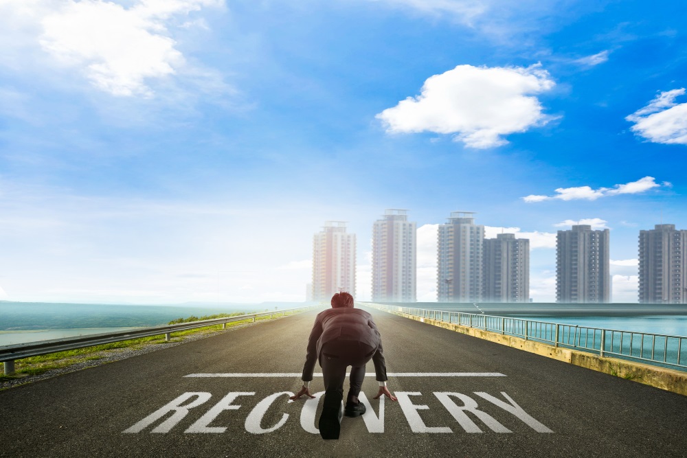 business man running the race to recovery