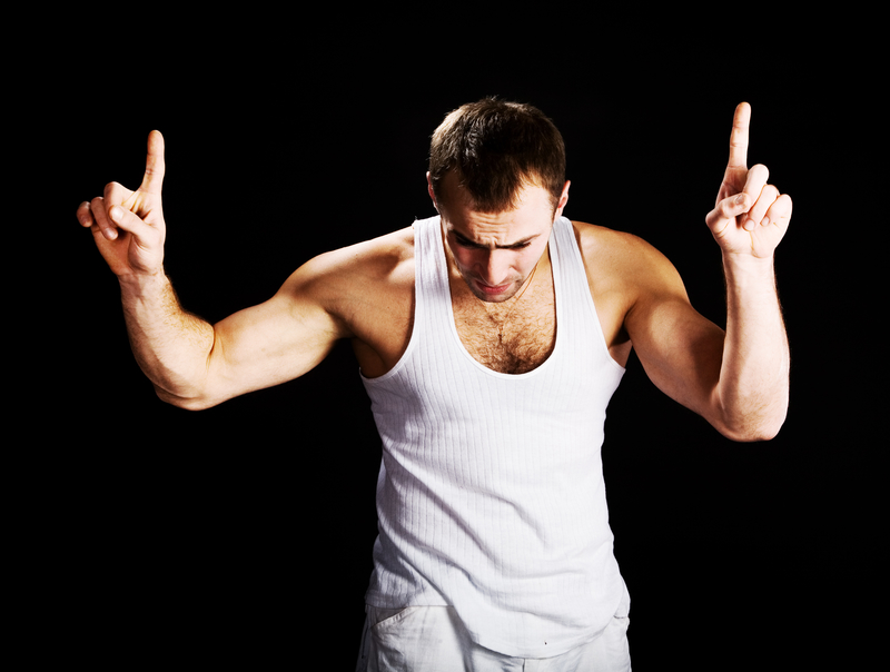 A man standing with his hands up, as if telling a story.