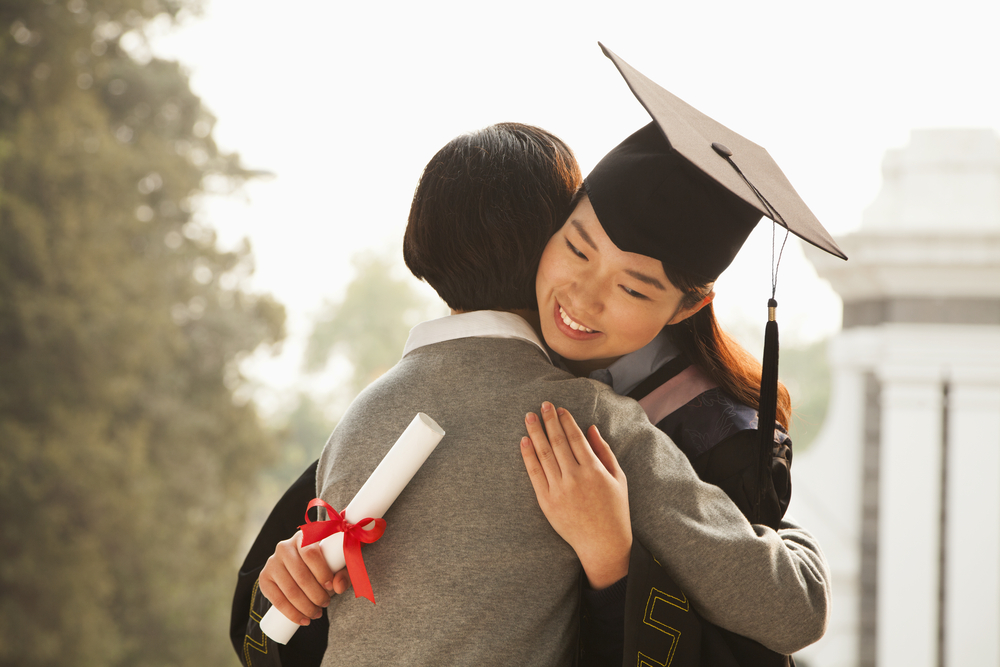 Mother hugging a graduate