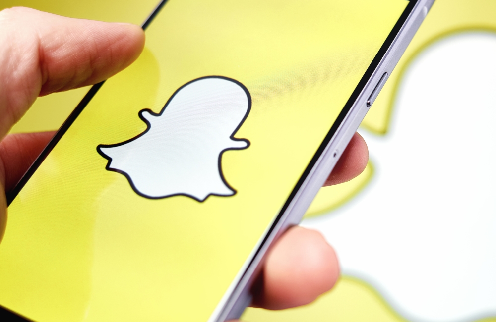 Snapchat app logo displayed on a smartphone.