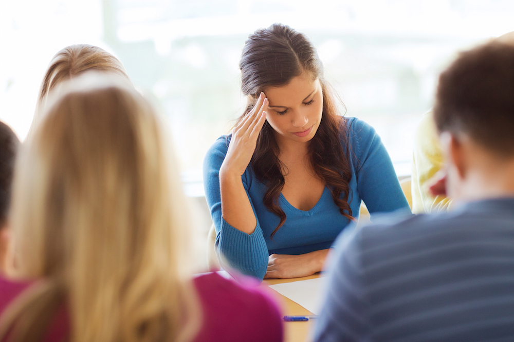 Worried student sitting in a classroom