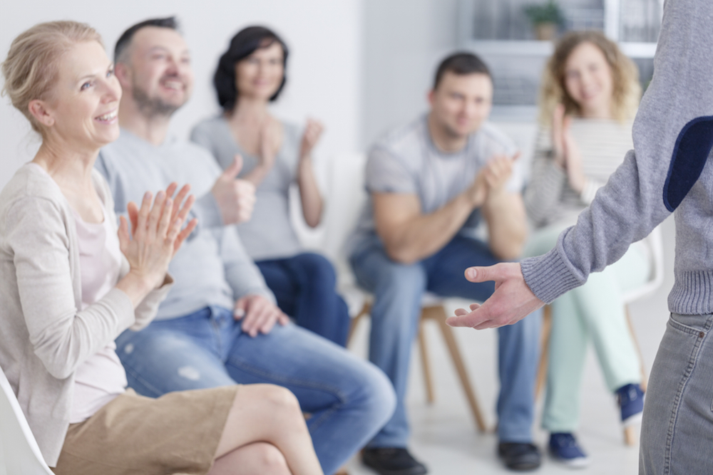 a group of people in a support group meeting