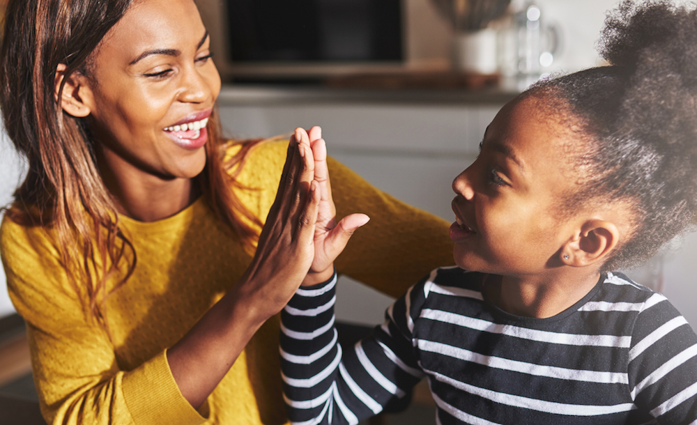 Mother and child high-fiving each other.
