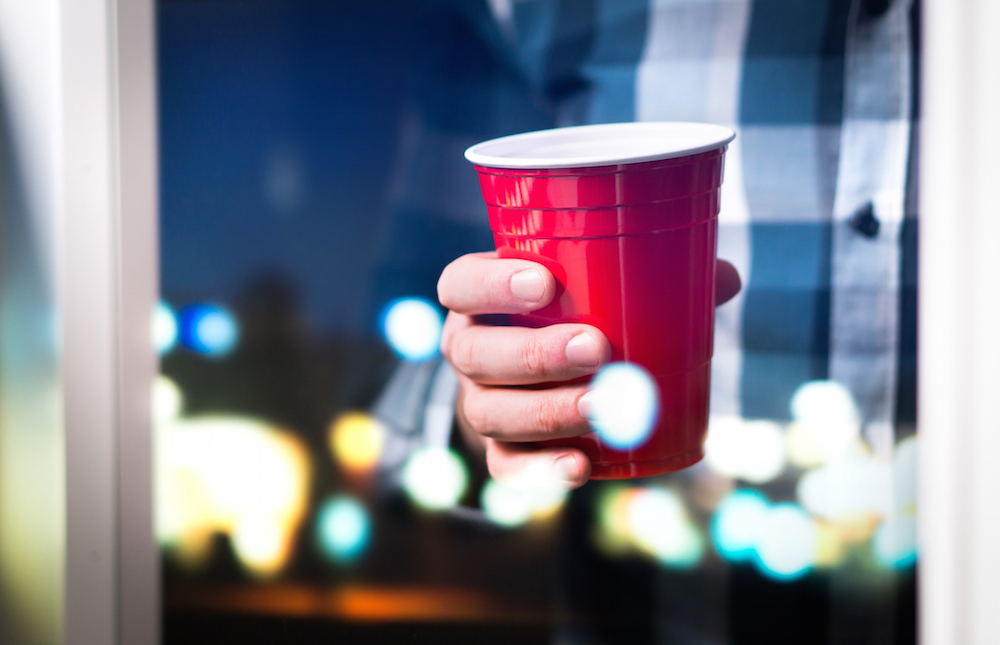 person holding a red cup