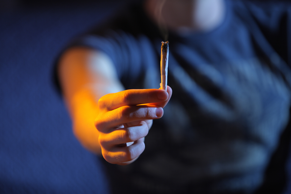 Teen holding a joint