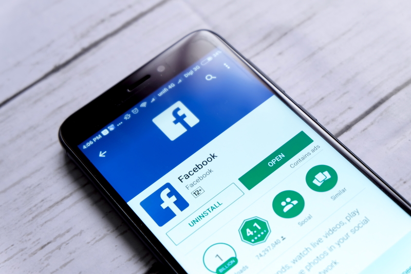 Top view of smartphone with Facebook apps on android Play Store.Facebook is an American online social media and social networking service based in Menlo Park, California