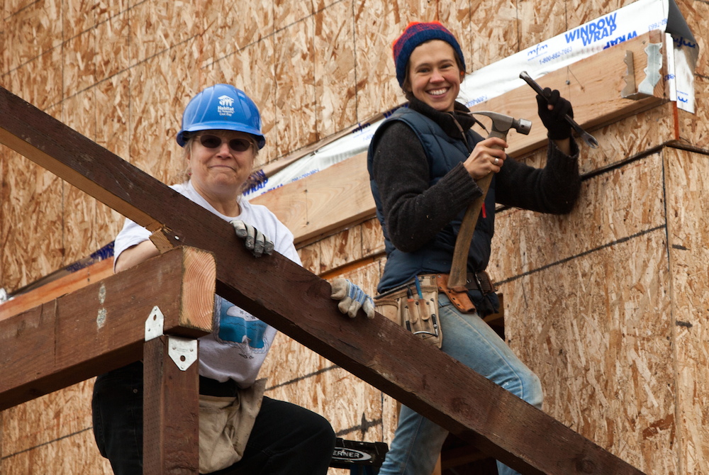 volunteers building house