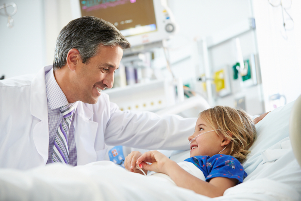 young girl talking to doctor in hospital