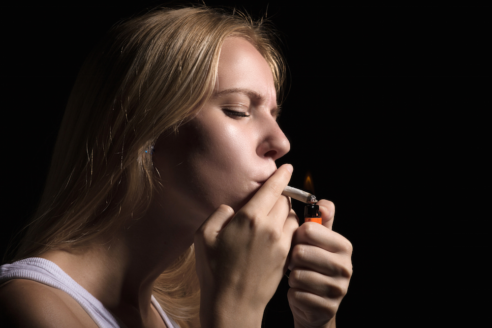 Woman lighting a joint