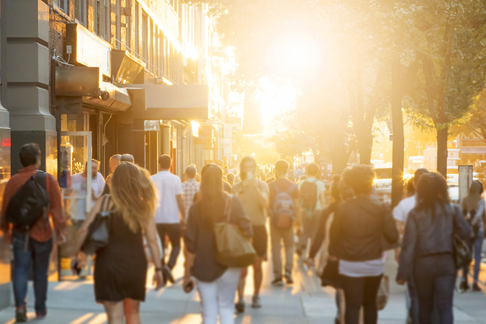 people walking down a sidewalk