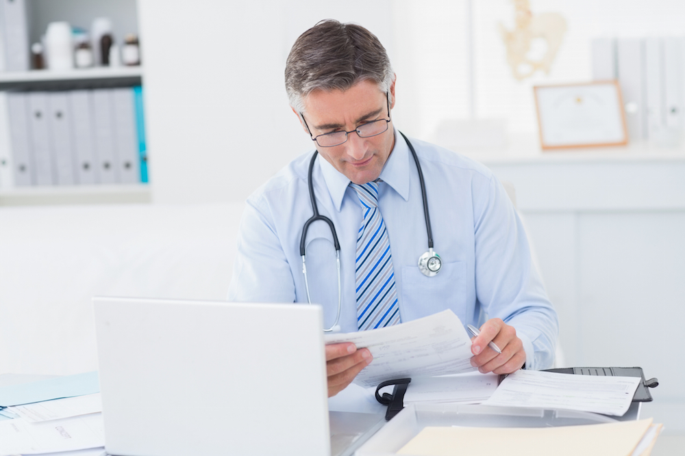 doctor reading document in office