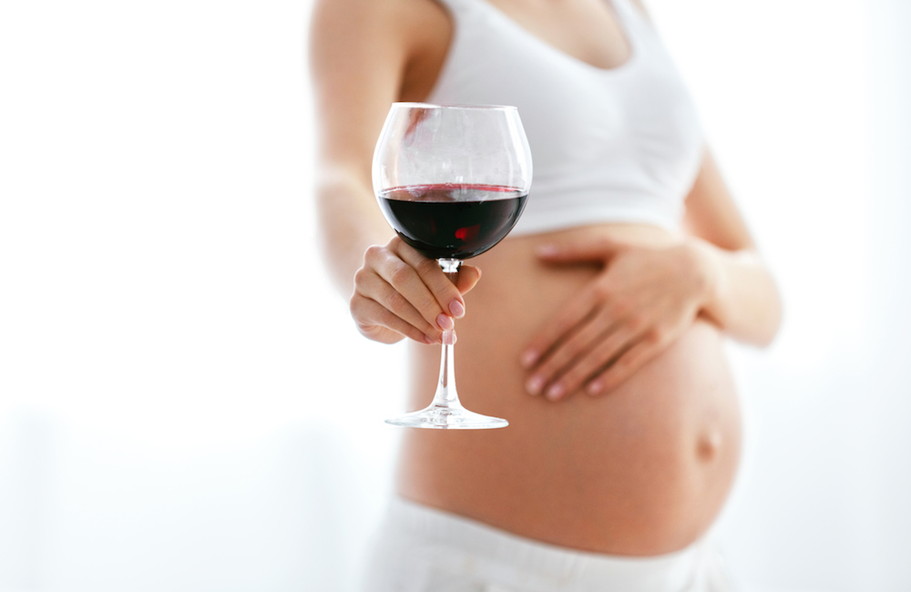 pregnant woman with glass of wine