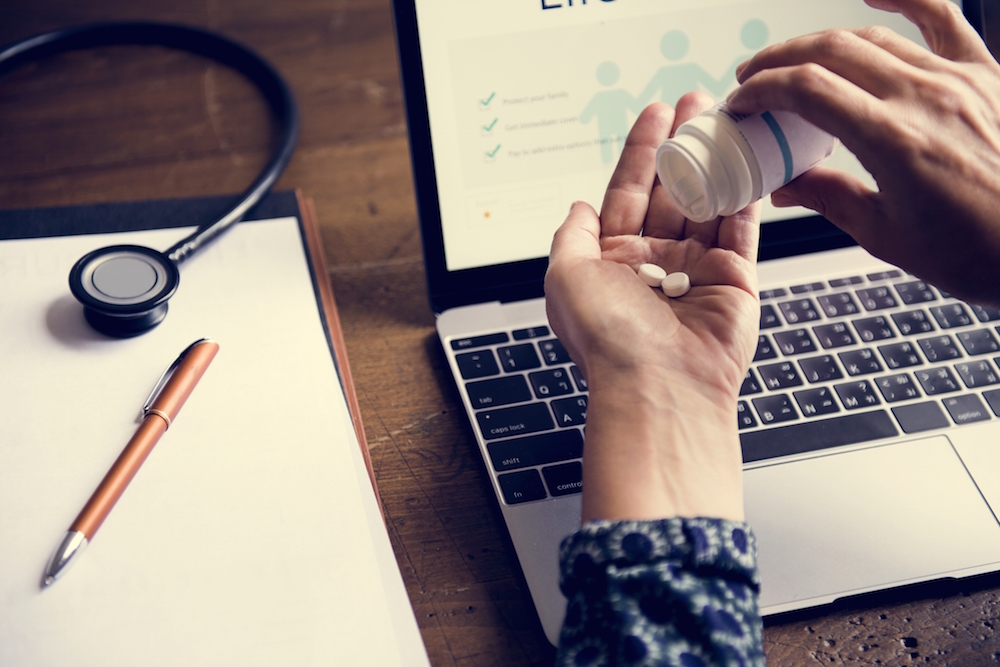 person pouring pills into their hand