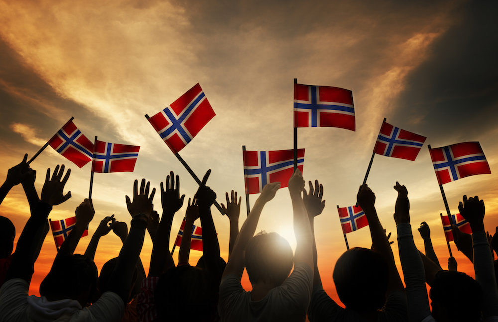 Group of people waving Norwegian flags