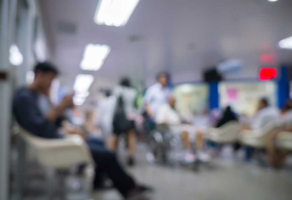 blurred image of patients seated in hospital waiting room