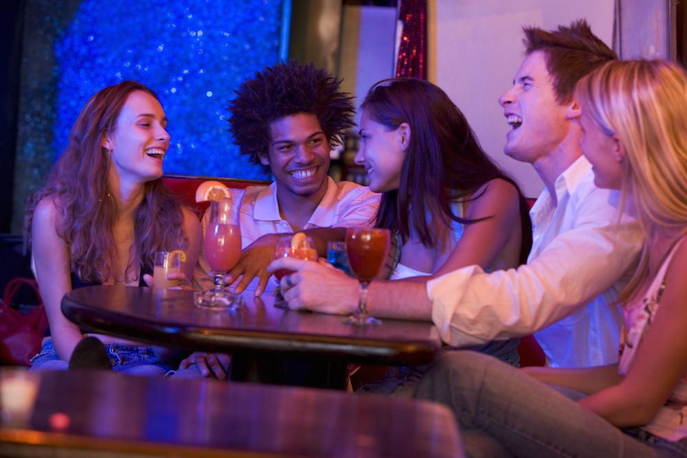 a group of young adults hanging out in a nightclub