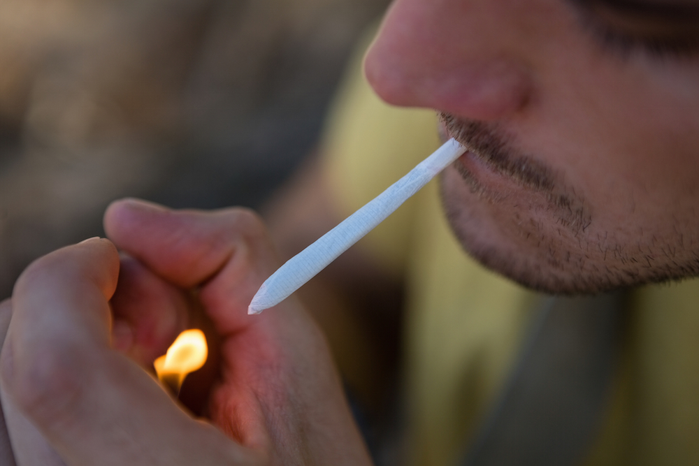 a man lighting a joint