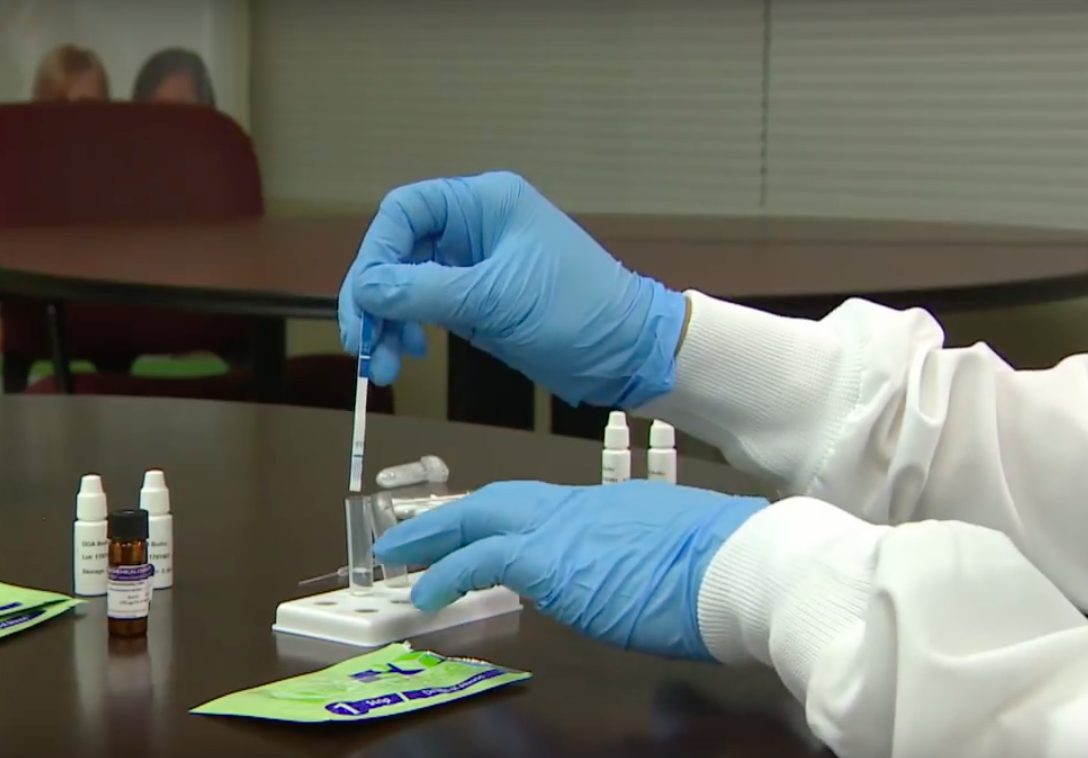 Scientist demonstrating fentanyl test strips