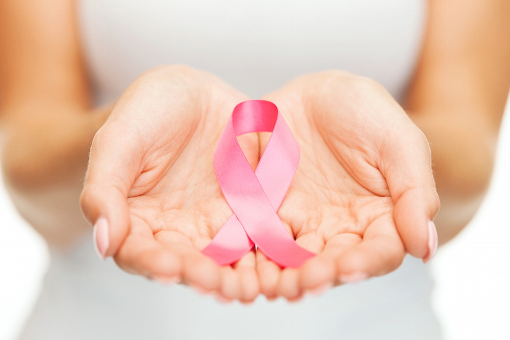 woman holding breast cancer awareness ribbon