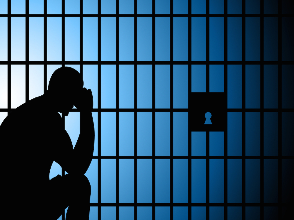 Man sitting in a jail cell