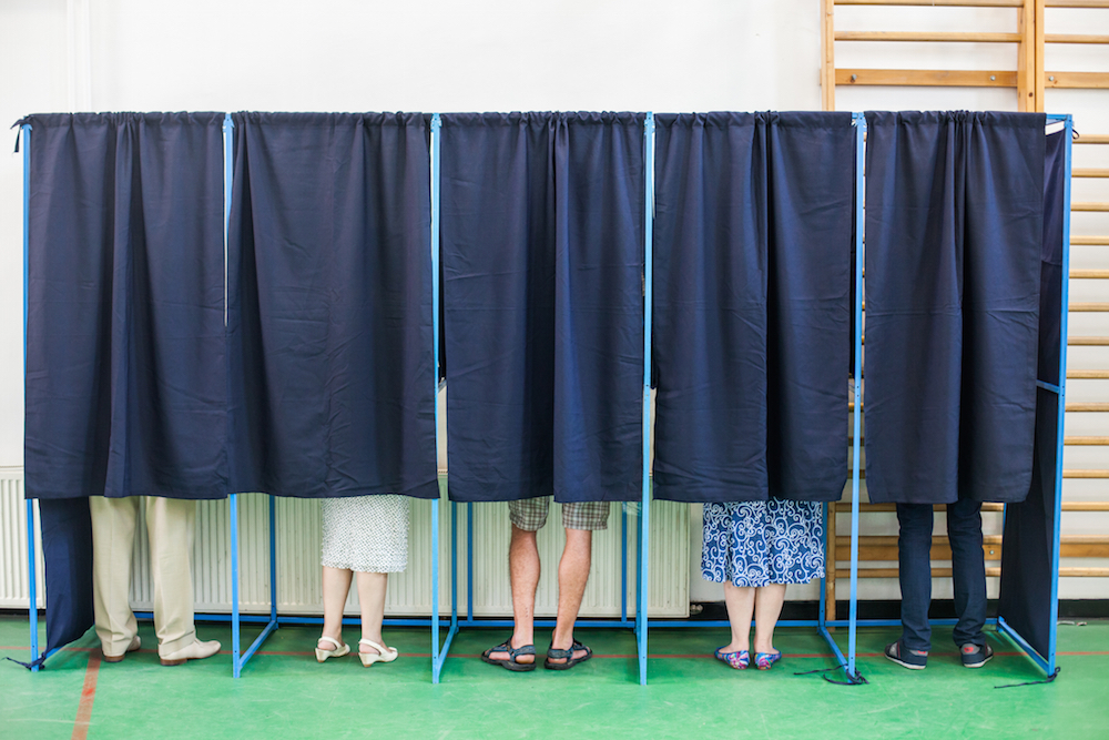 people inside voting booths