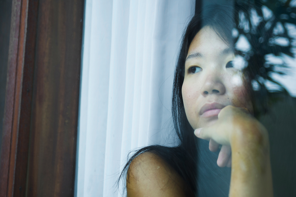 young girl looking out a window