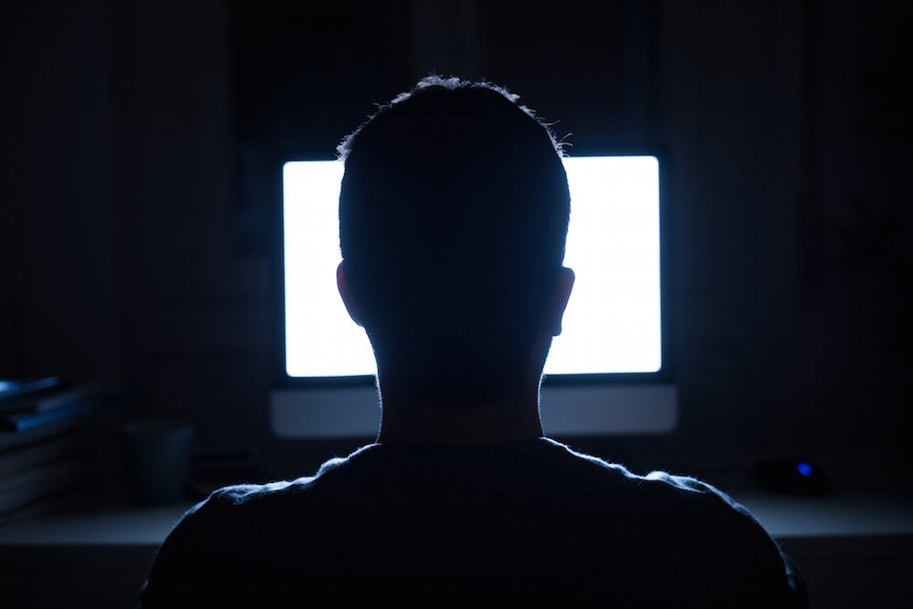 silhouette of a man in front of a computer dealing with sex addiction