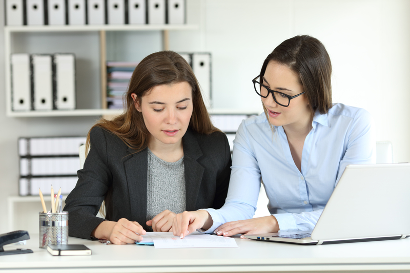 Woman advising other woman on managing her finances in recovery.