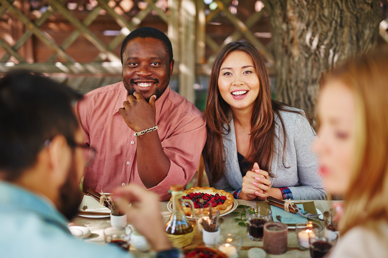 Smiling couple at Thanksgiving table, holiday sobriety