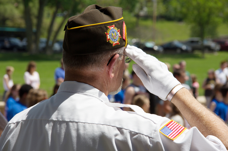 A proud veteran salutes the flag at a Memorial Day