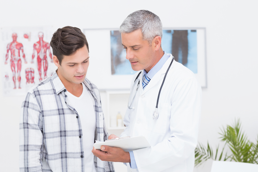 doctor talking to male patient about his sperm count